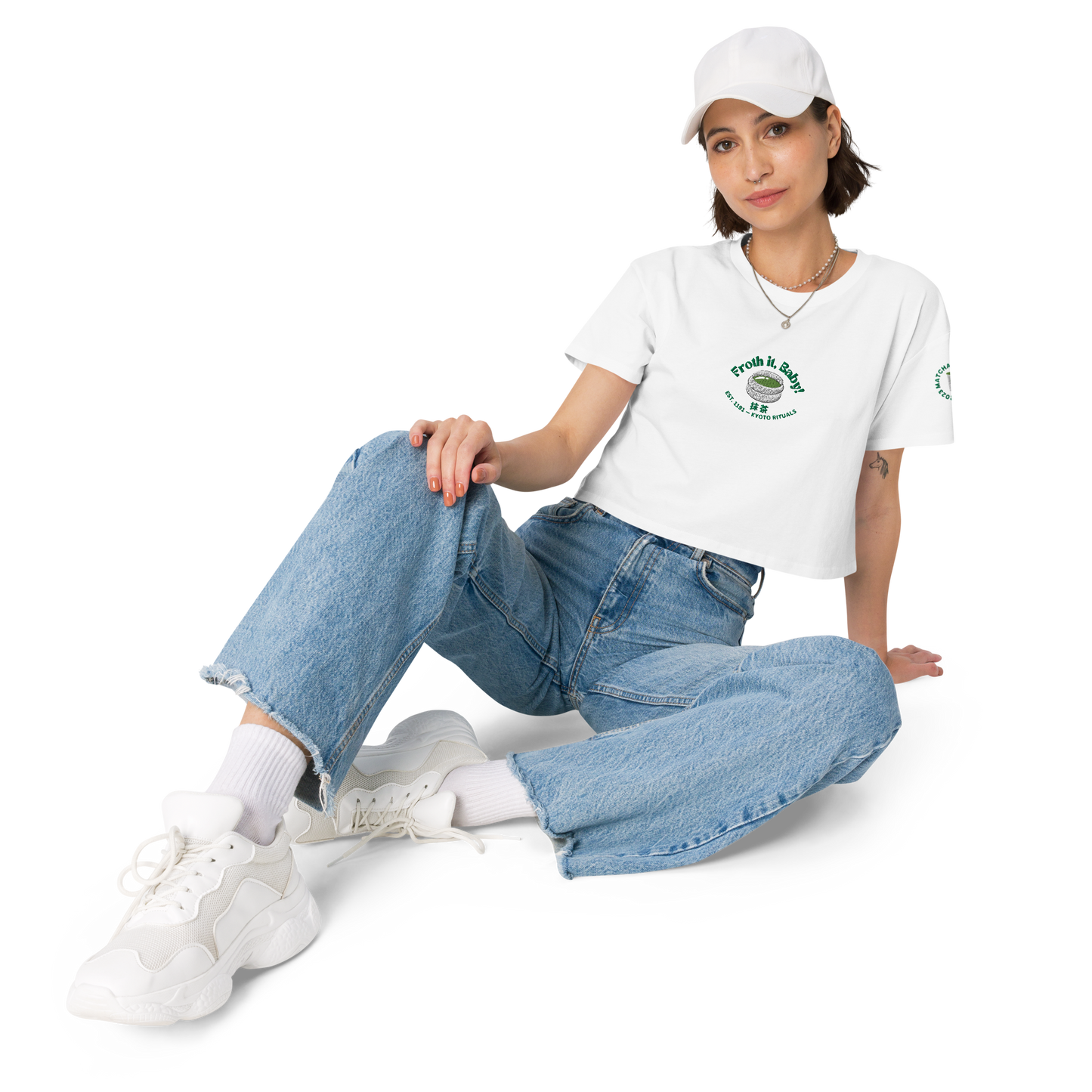 Person wearing a white t-shirt, blue jeans, and white sneakers on a white background